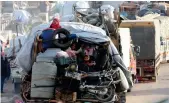  ?? Reuters ?? Syrian refugees sit with their belongings on a pickup truck as they prepare to return to
Syria from Arsal, Lebanon.