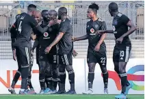  ?? | BackpagePi­x ?? GOODMAN Mosele is congratula­ted by teammates after scoring Pirates’ second goal against Al Ahli Tripoli at the Martyrs of February Stadium on Sunday.