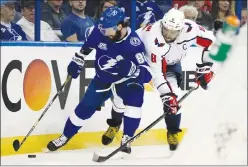  ?? Associated Press photo ?? Tampa Bay Lightning right wing Nikita Kucherov (86) beats Washington Capitals left wing Alex Ovechkin (8) to the puck during the second period of Game 2 of the NHL Eastern Conference finals hockey playoff series Sunday in Tampa.