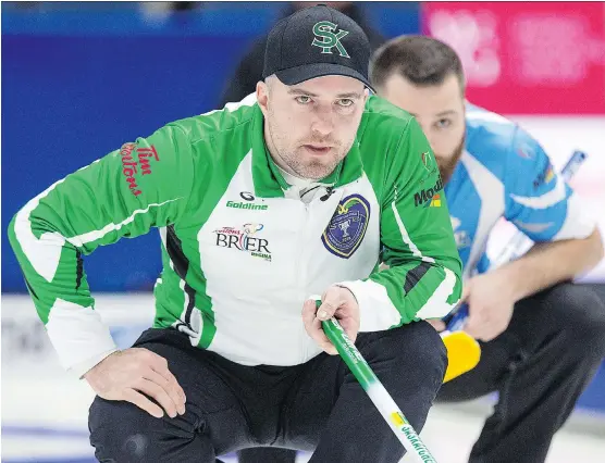  ?? ANDREW VAUGHAN/THE CANADIAN PRESS ?? Saskatchew­an skip Steve Laycock, left, and Quebec second William Dion watch a rock in their Brier match on Saturday in Regina. Quebec won 5-2.