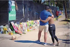  ?? ROBERT BUMSTED/ASSOCIATED PRESS ?? Two people who knew an unidentifi­ed victim of a fatal incident at the Houston Astroworld concert embrace at a memorial on Sunday.