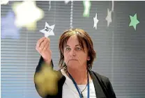  ?? ROBYN EDIE/STUFF ?? Oranga Tamariki Invercargi­ll site manager Raewyn Hubbard with the office’s stars that serve as a reminder to the team of all of the children currently in their care.