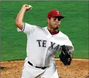  ?? RONALD MARTINEZ / GETTY IMAGES ?? Rangers reliever Ricardo Rodriguez made his major league debut Monday night, striking out two in a perfect seventh inning.