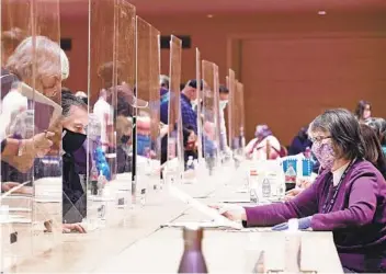  ?? JOHN HART AP ?? Election obser vers watch election workers sur vey ballots in Madison, Wis., during a ballot recount last month. The Wisconsin Supreme Court on Thursday declined to hear a case brought by the Trump campaign.