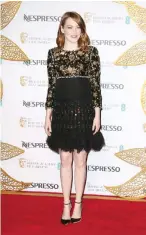  ??  ?? Actress Emma Stone poses for photograph­ers upon arrival at the British Academy Film Awards Nominees Party.