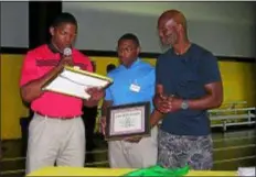  ?? KEVIN TUSTIN — DIGITAL FIRST MEDIA ?? Students Corde Fitzhugh, left, and DerShaun McPherson, middle, present retired boxer Bernard Hopkins with special honors during his visit to the Glen Mills Schools on Tuesday.