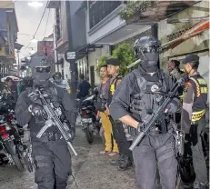  ??  ?? This file picture shows Indonesian anti-terror policemen conducting a raid in Surabaya. — AFP photo