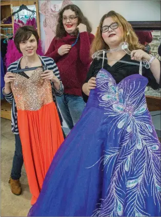  ?? WILLIAM HARVEY/TRILAKES EDITION ?? Arkadelphi­a Human Developmen­t Center resident Candie Jo Butler, center, shows a possible jewelry selection, while residents Kelsey Heffner, left, and Hannah White show possible ball-gown selections for Winter Wonderland Prom 2018. Formalwear for women...