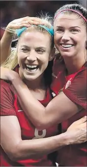  ?? Chris Graythen Getty Images ?? JULIE ERTZ, left, the U.S. female player of the year in 2017, is shown with teammate Alex Morgan.