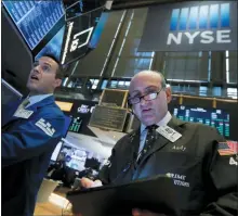  ?? AP PHOTO/RICHARD DREW, FILE ?? FILE- In this July 1, 2019, file photo specialist Michael Gagliano, left, and trader Andrew Silverman work on the floor of the New York Stock Exchange. The U.S. stock market opens at 9:30 a.m. EDT on Wednesday, July 17.