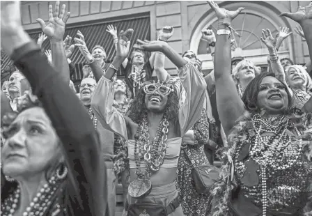  ?? CHANDAN KHANNA/AFP VIA GETTY IMAGES ?? Revelers catch beads during a Mardi Gras celebratio­n in New Orleans Tuesday.