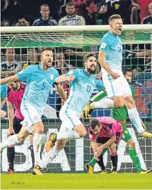 ?? Pictures: PA/SNS Group. ?? Left: Robert Snodgrass hooks in Scotland’s second goal; above: Roman Bezjak takes to the air to celebrate after netting his second to put Slovenia ahead.