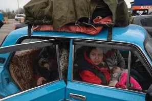  ?? The Associated Press ?? ■ Internally displaced people from Mariupol and nearby towns arrive at a refugee center on April 21, 2022, in Zaporizhzh­ia, Ukraine, while fleeing from the Russian attacks.