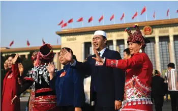  ?? — AFP photo ?? Delegates arrive for the closing ceremony of the Chinese People’s Political Consultati­ve Conference (CPPCC) at the Great Hall of the People in Beijing.