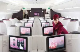  ??  ?? A flight attendant arranges a passenger booth in the first-class cabin aboard an Airbus SAS A380 aircraft, operated by Qatar Airways Ltd., on the opening day of the 51st Internatio­nal Paris Air Show in Paris, France. (Bloomberg file photo)