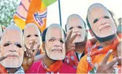  ?? PTI ?? BJP supporters wearing Modi mask show victory sign during an election campaign in Bengaluru on Monday
