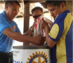  ??  ?? Putting the sand and gravel filters in biosand container: Pres. Rellie Francisco, PE James Jung and PP Jon Chua