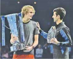  ??  ?? Zverev (left) chats to Djokovic as they pose with their trophies after the men’s singles final match on day eight of the ATP World Tour Finals. — AFP photo