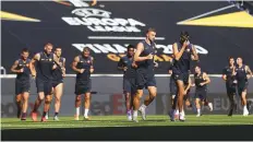  ?? AFP ?? Roma’s players including Lorenzo Pellegrini (right) and Edin Dzeko take part in a training session on the eve of the Europa League round of 16 match against Sevilla in Duisburg.