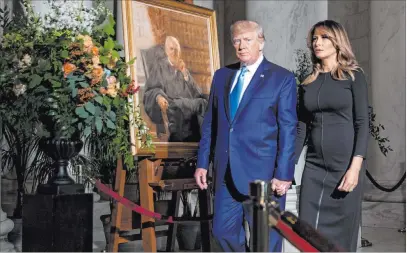  ?? Andrew Harnik The Associated Press ?? President Donald Trump and first lady Melania Trump walk past a painting of the late Supreme Court Justice John Paul Stevens after paying their respects Monday as he lies in repose in the Great Hall of the Supreme Court in Washington.