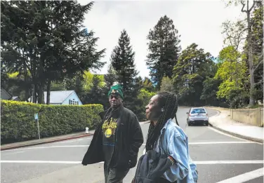  ?? Photos by Yalonda M. James / The Chronicle ?? Greg Dunston, 61, and partner Marie McKinzie, 53, walk back home after visiting Hampton Park in Piedmont. The pair, formerly homeless, moved into the in-law unit of a Piedmont man’s home.