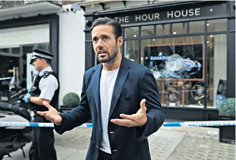  ??  ?? Customer Spencer Matthews outside The Hour House after the raid. Left, two of the robbers flee. Below, a hammer on the shop floor. Right, one of the mopeds abandoned