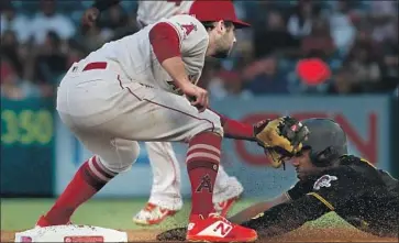  ?? Luis Sinco Los Angeles Times ?? ANGELS SHORTSTOP David Fletcher tags out the Pirates’ Starling Marte at second base in the first inning.