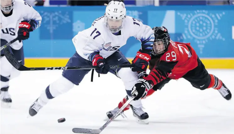  ?? JULIO CORTEZ / THE ASSOCIATED PRESS FILES ?? Jocelyne Lamoureux-Davidson of the U. S. battles Canadian Marie-Philip Poulin during action at the Pyeongchan­g Winter Olympics.