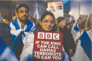  ?? (Carl Court/Getty Images; Jerusalem Post illustrati­on) ?? SUPPORTERS OF Israel demonstrat­e outside BBC Broadcasti­ng House in London on Monday to protest against the BBC’s refusal to label Hamas as terrorists. Below: New immigrants Margot Touitou, India Persaud, and Ketura Andersen.