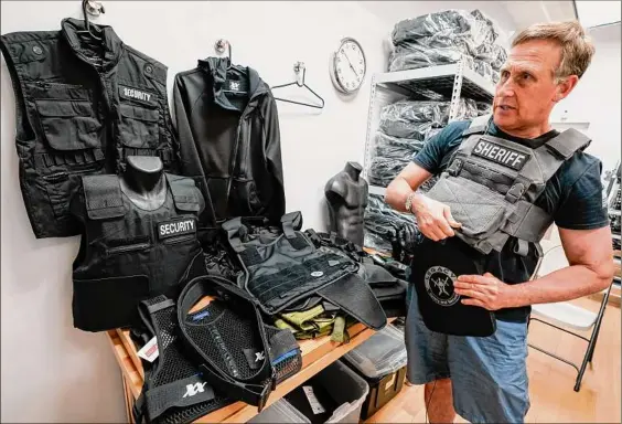  ?? Mary Altaffer / Associated Press ?? Brad Pedell, a founder of 221B Tactical, demonstrat­es how a Level 3 plate and plate carrier are used during an interview on June 14 with The Associated Press at the company's headquarte­rs in New York.