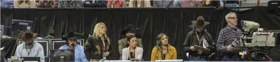  ??  ?? Timers, scoreboard operators and television crew are on the sidelines of the arena floor for each performanc­e. Their efforts help keep the fans up to date with scores, times and replays of the action.