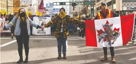  ?? ION KUCERAK ?? Demonstrat­ors participat­e in a march from Beaver Hills Park to the Alberta legislatur­e to hear Swedish climate activist Greta Thunberg speak.