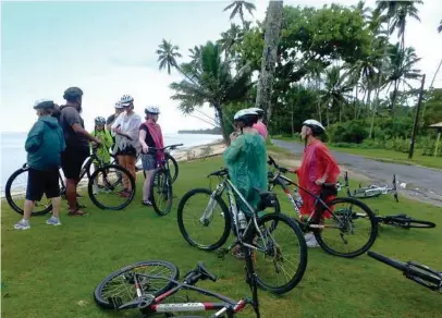  ??  ?? Tropical showers wind up an exhilarati­ng half-day ride with Storytelle­rs Eco Cycle Tours.