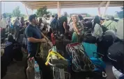  ?? SAM MEDNICK — THE ASSOCIATED PRESS ?? French and other nationals gather at the internatio­nal airport to be airlifted back to France on a French military aircraft, in Niamey, Niger, on Wednesday.