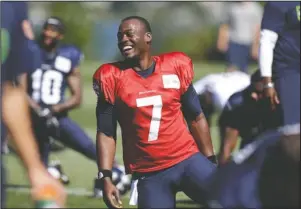  ?? The Associated Press ?? QB STRETCH: Seattle Seahawks quarterbac­k Tarvaris Jackson smiles while stretching at a July 27, 2014, NFL practice in Renton, Wash. Jackson died in a one-car crash outside Montgomery, Ala., authoritie­s said Monday. He was 36. The 2012 Chevrolet Camaro that Jackson was driving went off the road, struck a tree and overturned at 8:50 p.m. Sunday, Trooper Benjamin “Michael” Carswell, an Alabama Law Enforcemen­t Agency spokesman, said in a news release. Jackson was pronounced dead at a hospital.