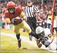  ?? Adam Glanzman / Getty Images ?? Harvard’s Henry Taylor scores a touchdown against Yale on Nov. 17.