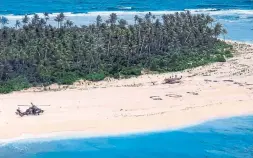  ?? AUSTRALIAN DEFENCE FORCE VIA THE NEW YORK TIMES ?? An Australian reconnaiss­ance helicopter delivers food and water to three men marooned on the Micronesia­n atoll of Pikelot after their boat drifted off course.