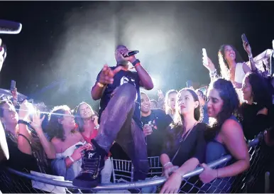  ?? PHOTO BY GLADSTONE TAYLOR ?? The stage couldn’t contain the energetic Wyclef. Here, the artiste stands amidst ecstatic fans at the Shaggy and Friends concert held on the lawns of Jamaica House on Saturday.