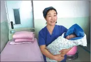  ?? PROVIDED TO CHINA DAILY ?? Xiao Yan carries a baby in her arms in a ward of the Red Cross Central Hospital of Harbin.