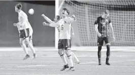  ?? MICHAEL LAUGHLIN/SUN SENTINEL ?? Fort Lauderdale’s Gaberial Gonzalez and teammates celebrate their victory over St. Thomas Aquinas in their regional final soccer match Wednesday night.