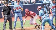  ?? AP/The Oxford Eagle/BRUCE NEWMAN ?? Arkansas outfielder Heston Kjerstad (18) makes it safely back to third base during a rundown Saturday during the Razorbacks’ 1110 loss to the Rebels in Oxford, Miss.