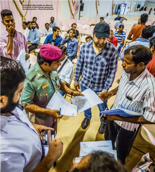  ?? —Photo: Neeraj Murali ?? AN OFFICER AND A GUIDE: An official on the first day of UAE Amnesty answered a few dozen queries.