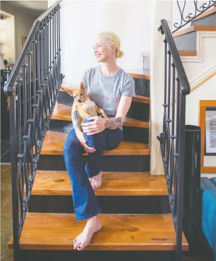  ?? CHRIS GRANGER, NOLA.COM | THE TIMES-PICAYUNE / FILES ?? Novelist Amanda Boyden seated on the stairs of her New Orleans home with her dog.