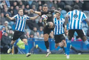  ?? ?? Jonson Clarke-Harris (dark shirt) is a top five striker in League One.