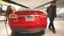  ??  ?? A MAN looks at Tesla Motors’ Model S P85 at its showroom in Beijing on Jan. 29, 2014.