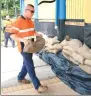  ?? GETTY IMAGES ?? A council worker lifts a sandbag in Townsville, Australia, in preparatio­n for Cyclone Debbie.