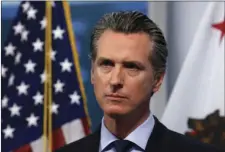  ?? AP PHOTO/RICH PEDRONCELL­I, POOL ?? In this April 9 file photo, California Gov. Gavin Newsom listens to a reporter’s question during his daily news briefing in Rancho Cordova, California.