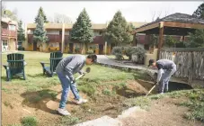  ?? FILE PHOTO ?? Brothers Manuel and Salvador Cordova clean the acequia that runs through El Pueblo Lodge in 2017.