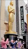  ??  ?? An Oscar statue is pictured outside the Dolby theatre during preparatio­ns leading up to the 87th Academy Awards in Hollywood, California (Reuters)