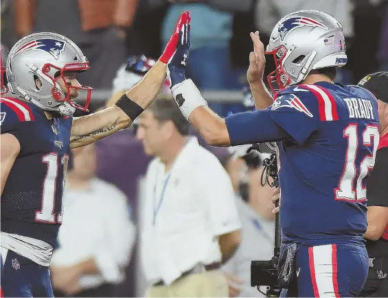  ?? STAFF PHOTO BY CHRISTOPHE­R EVANS ?? TWO GOOD: Tom Brady and Julian Edelman celebrate a touchdown during the Pats’ win over the Colts last night in Foxboro.